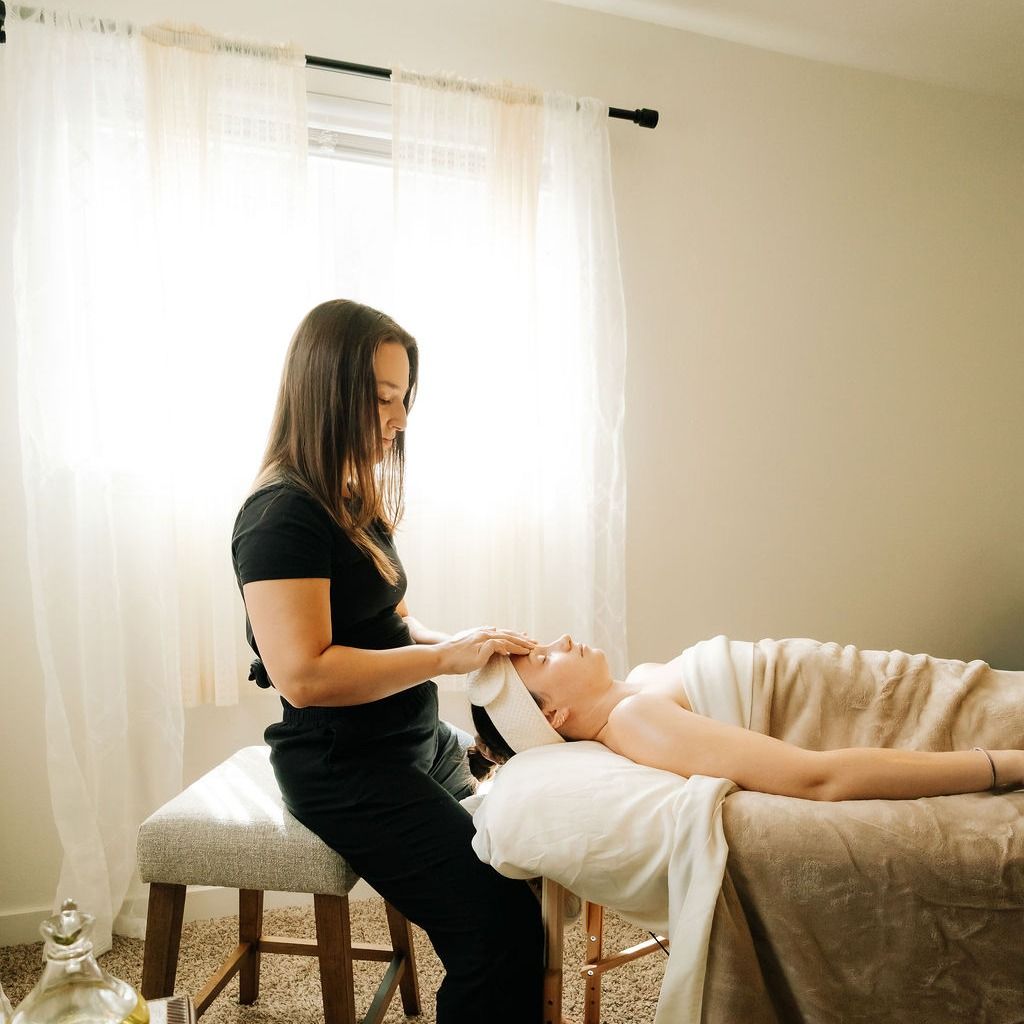 A massage therapist at work in a sunlit treatment room